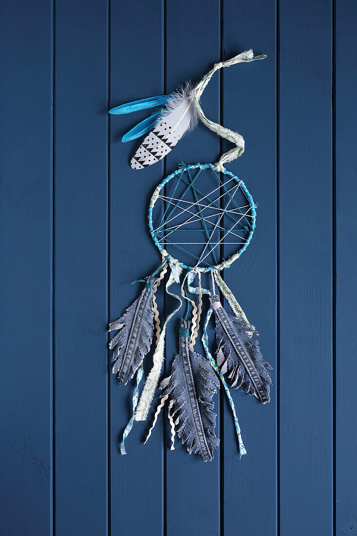 Dream catcher made from jeans fabric remnants with feathers