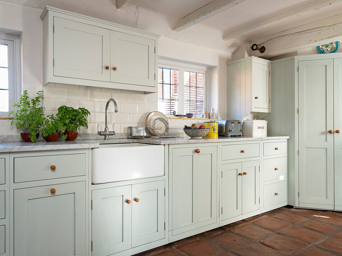 Light country kitchen with terracotta floor
