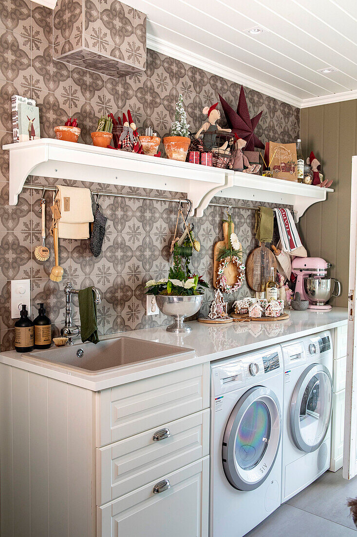 Laundry room with Christmas decorations and built-in washing machines