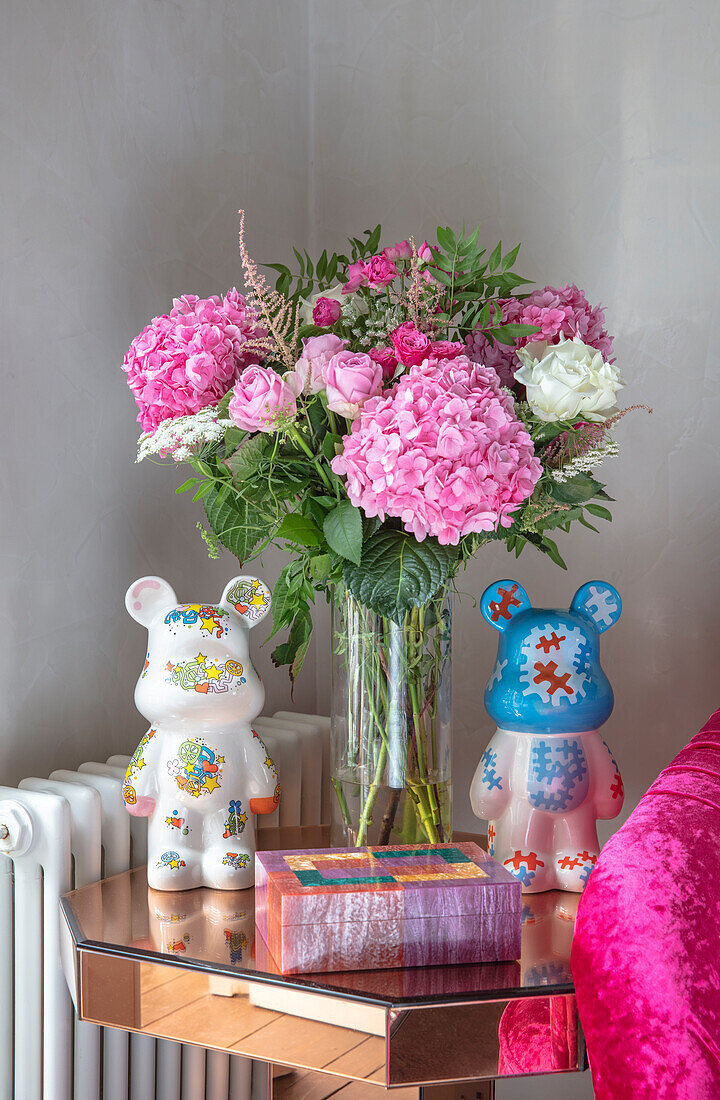 Porcelain bear and bouquet of flowers on gilded side table