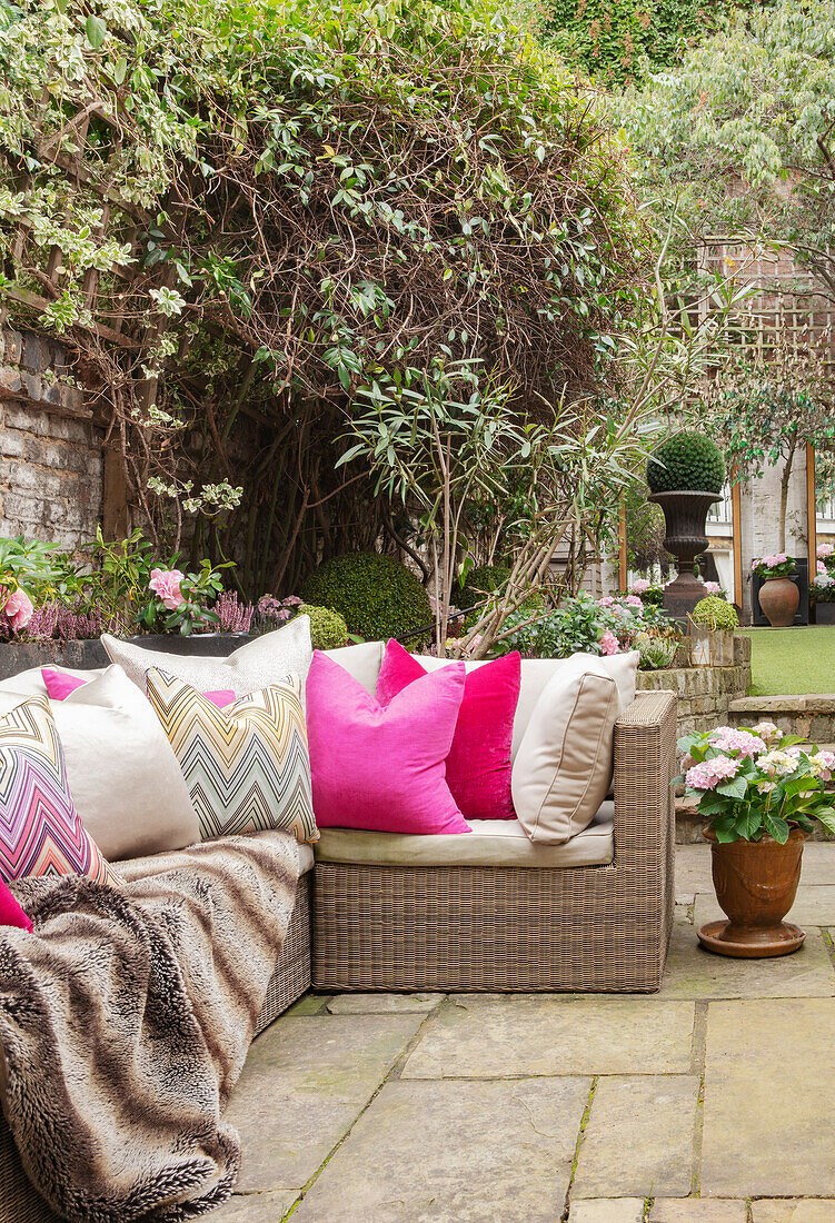 Outdoor sofa with cushion and blanket on the terrace