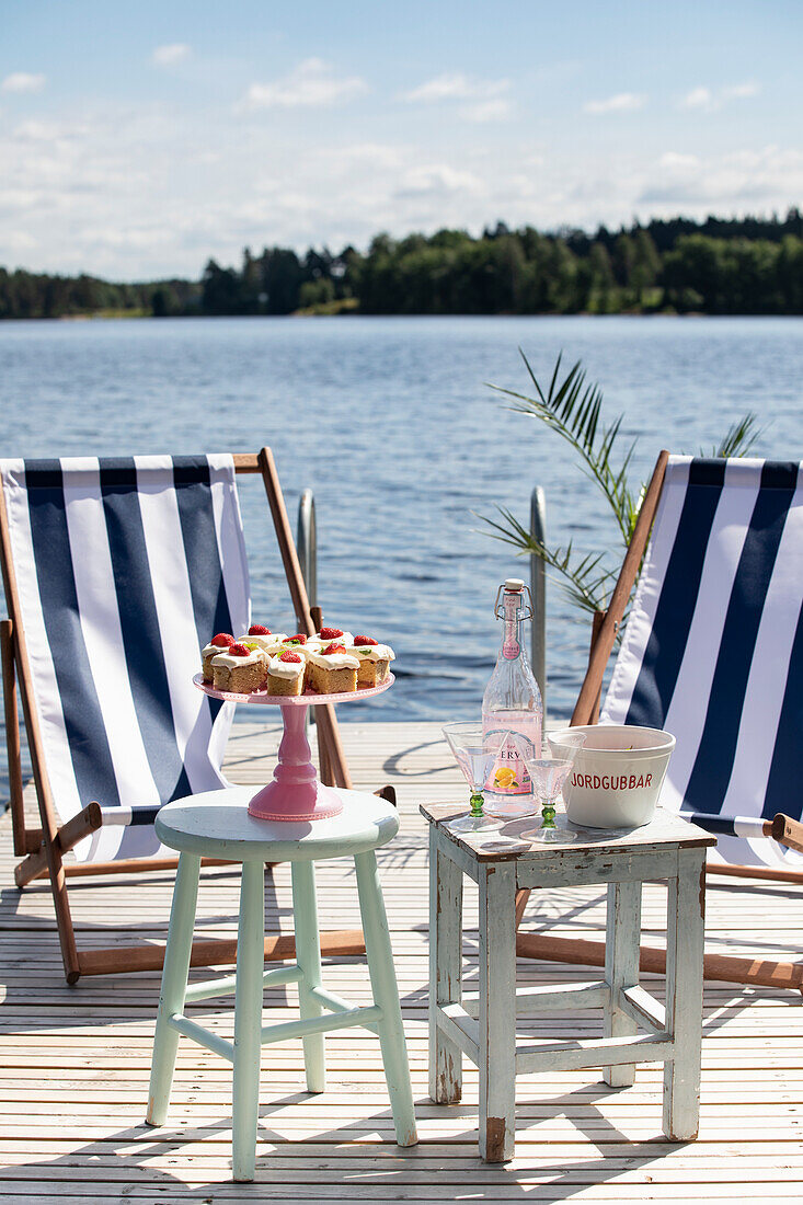 Picnic with cake on a dock by the lake