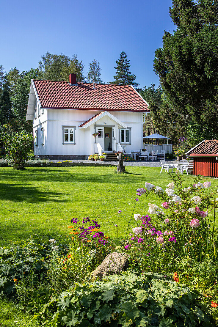 White single family house with a garden