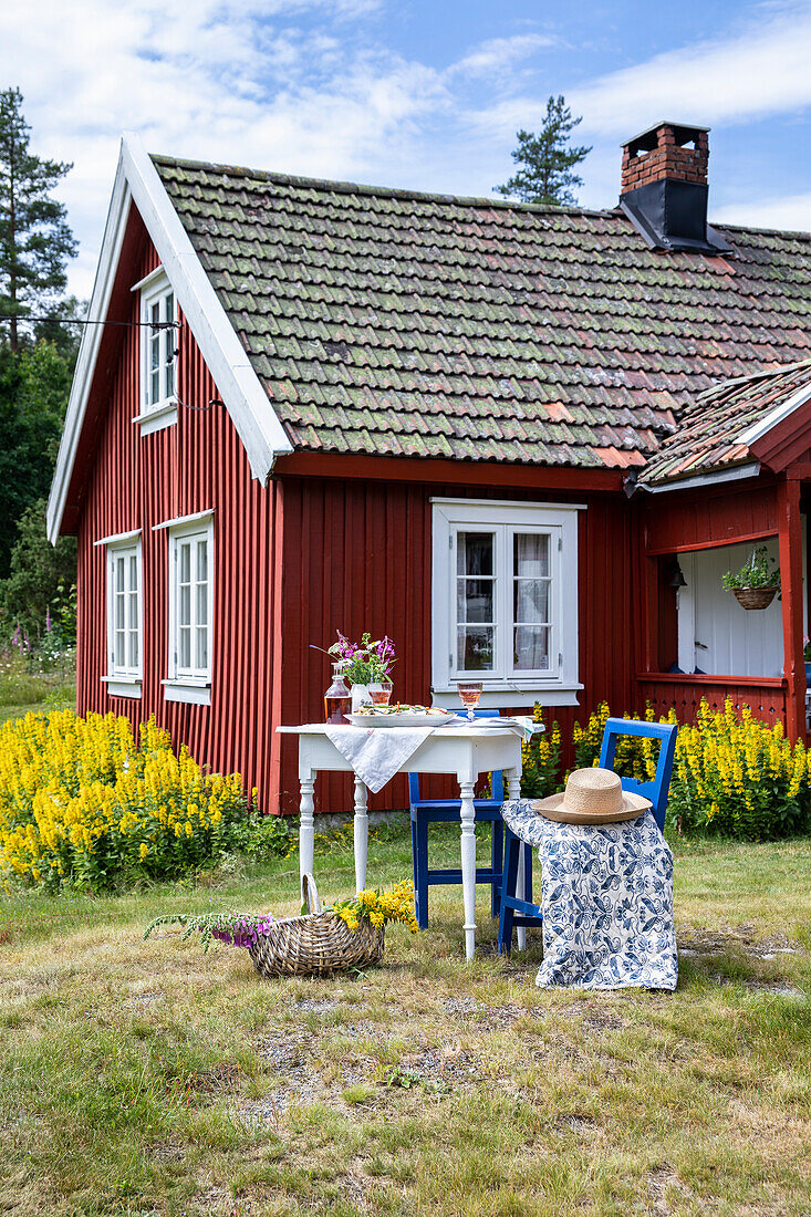 Red painted Swedish cottage with patio area