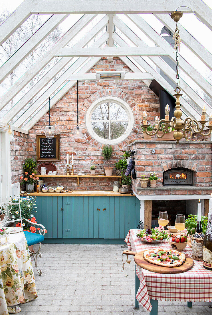 Kitchen in a cottage with brick walls and glass roof