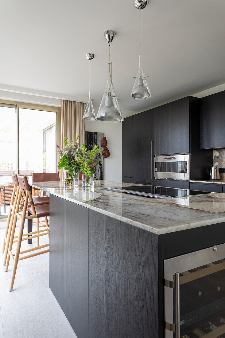 Elegant kitchen with black cabinet fronts and granite countertop