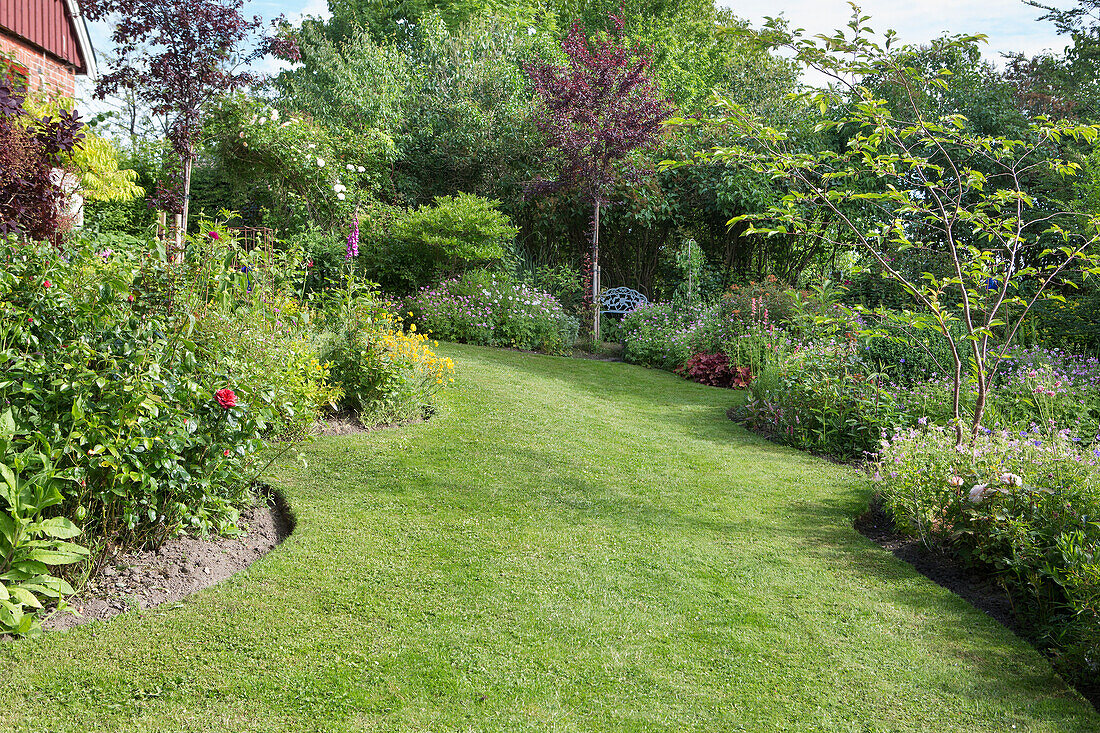 Lawn surrounded by flower borders