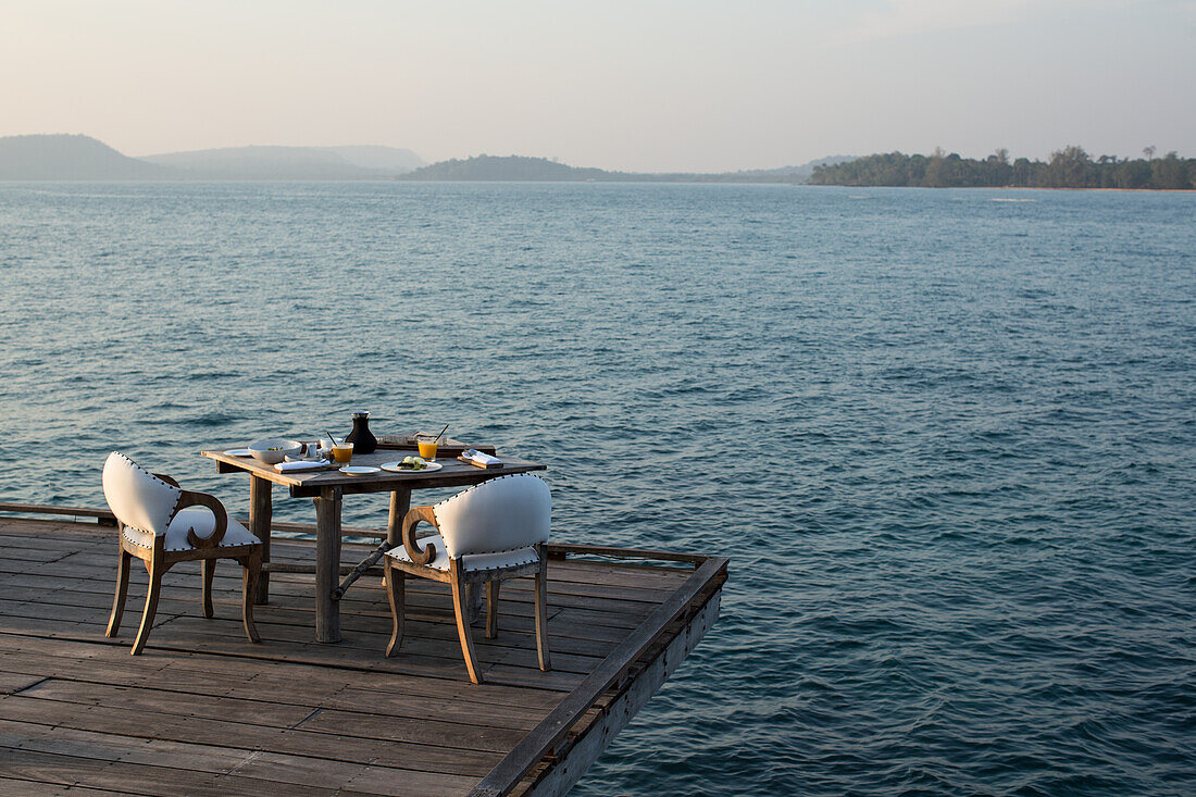 Set table for two on terrace over the sea, Cambodia