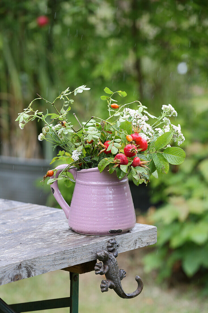 Rose hips and yarrow in vase
