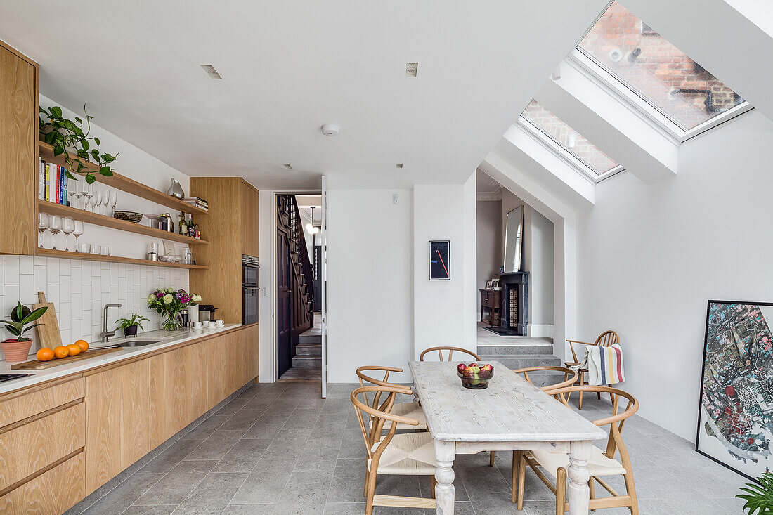 Oak kitchen and dining area in living room with skylights