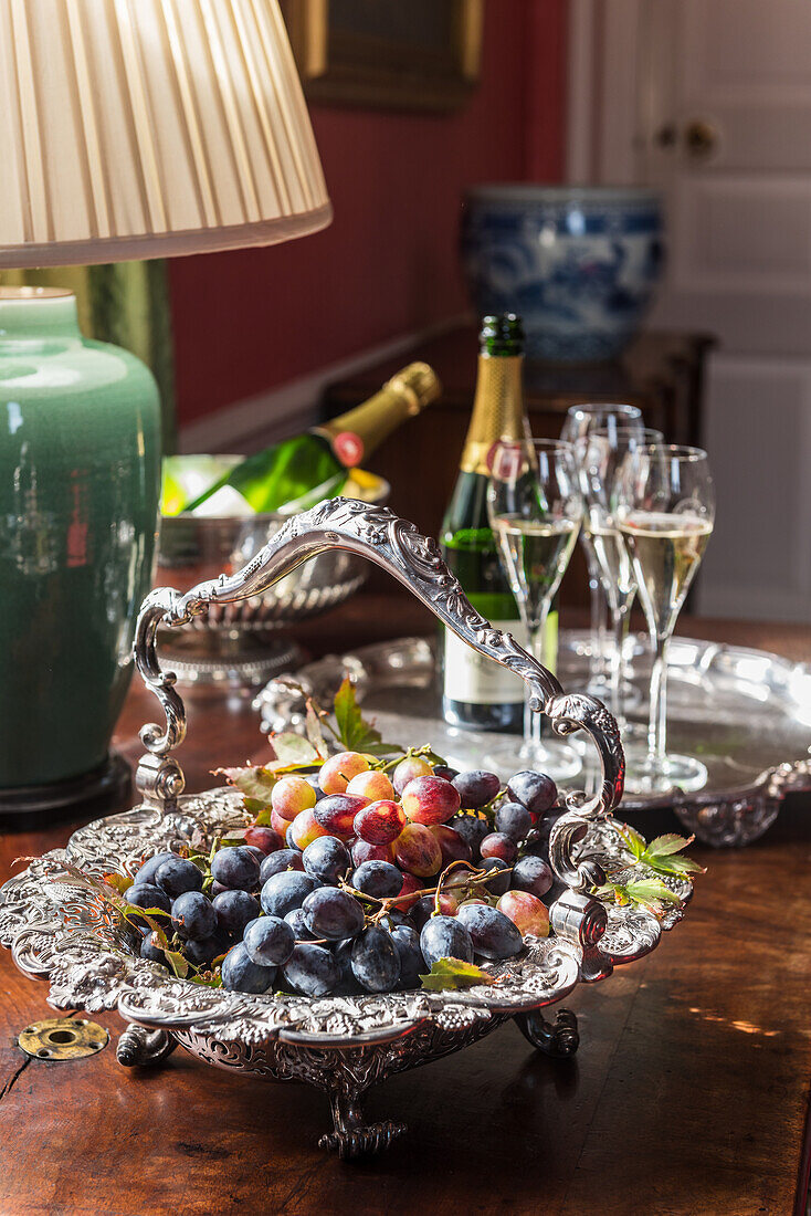 Grapes in silver bowl and sparkling wine