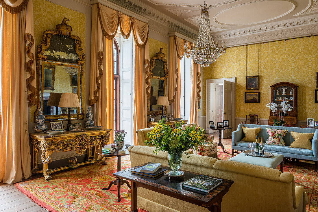 Golden drawing room with Victorian chandelier in a 17th century English country house