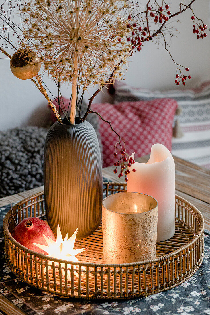 Weihnachtsdeko mit getrockneten Blütenständen, Windlicht und Kerze auf Tablett