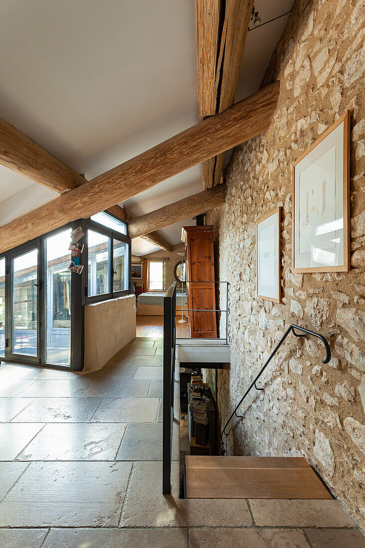 Entrance hall with natural stone wall in a country house