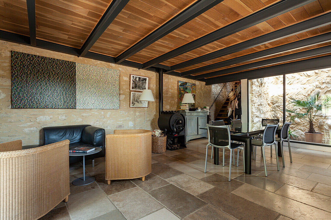 Sitting and dining area in open plan living room with stone tiles