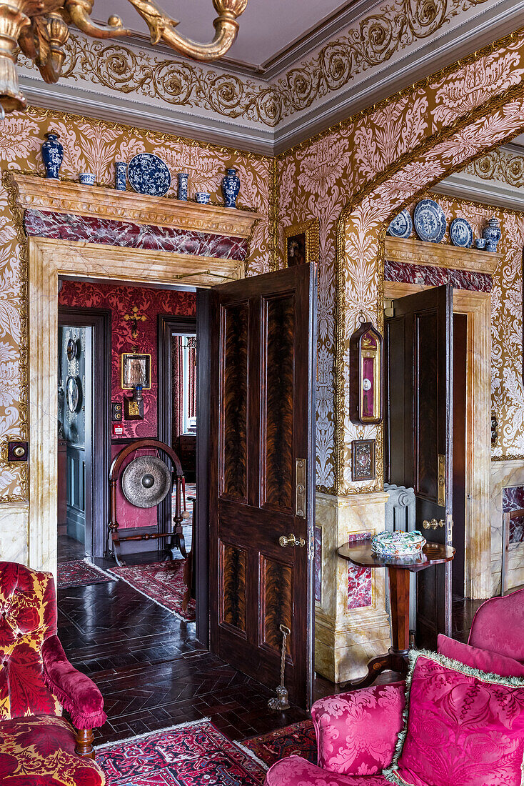 Opulent wallpaper and ornate ceiling
