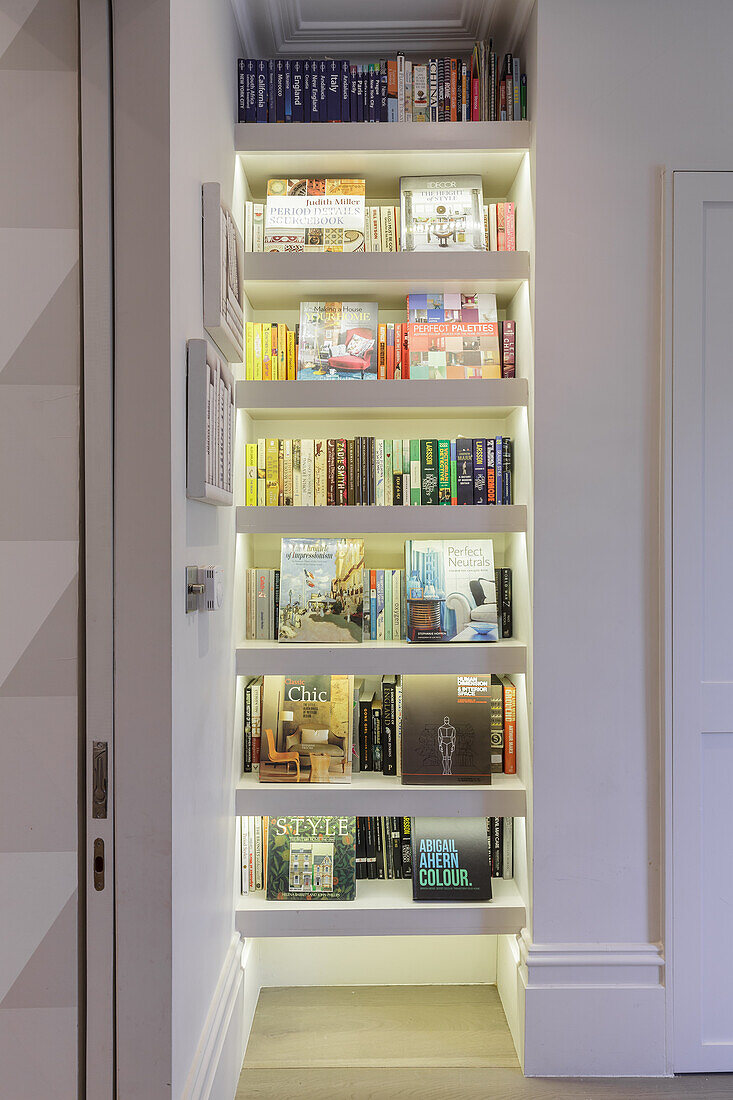 Room with a tall illuminated bookshelf