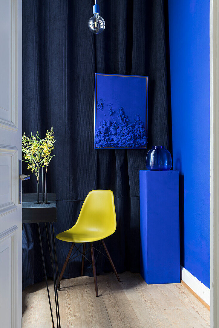 View into the study with ultra blue wall and yellow classic chair