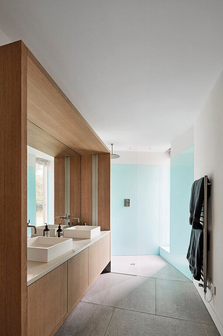 Ensuite bathroom with bespoke washstand and light blue glass panelling
