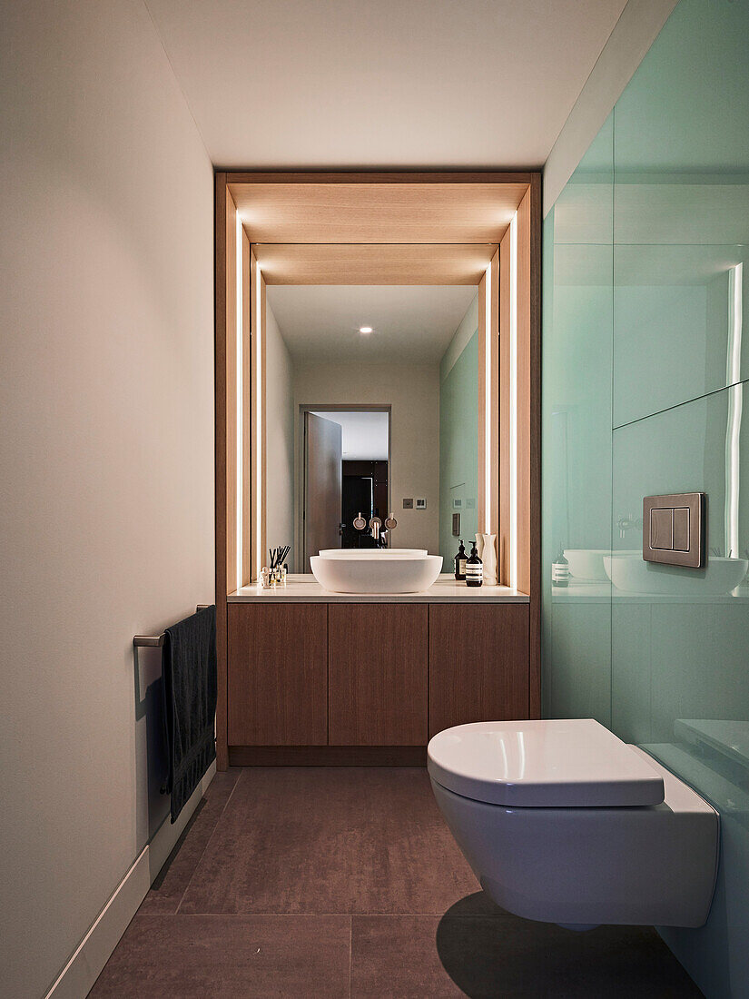 Guest toilet with custom washstand and light blue glass panelling