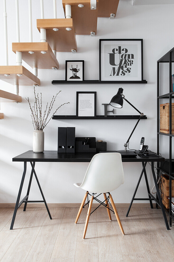 Home office in black and white under the stairs