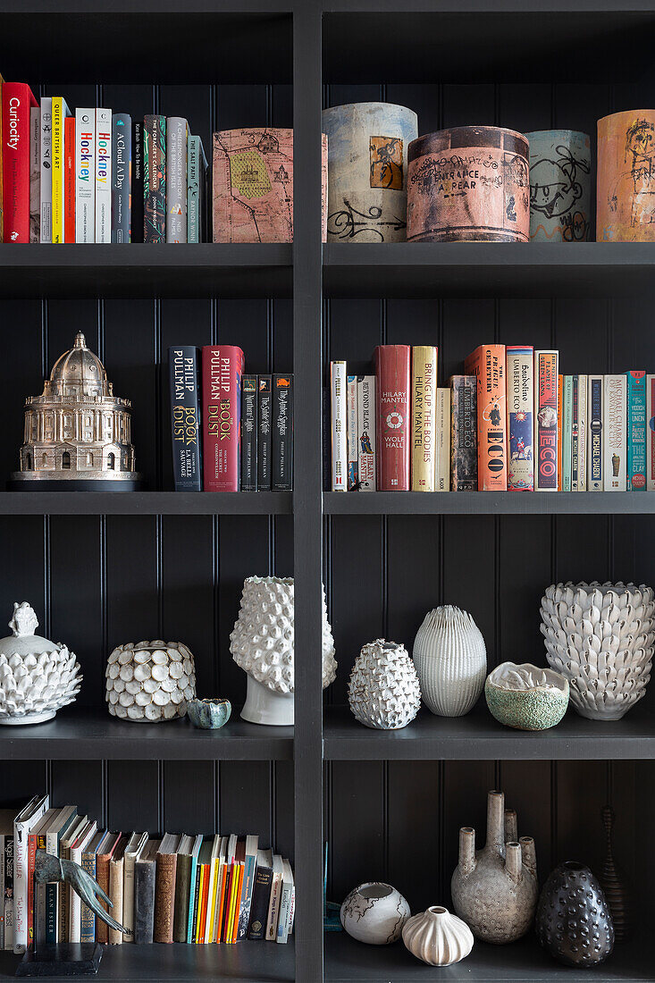 Black shelf with books and vases