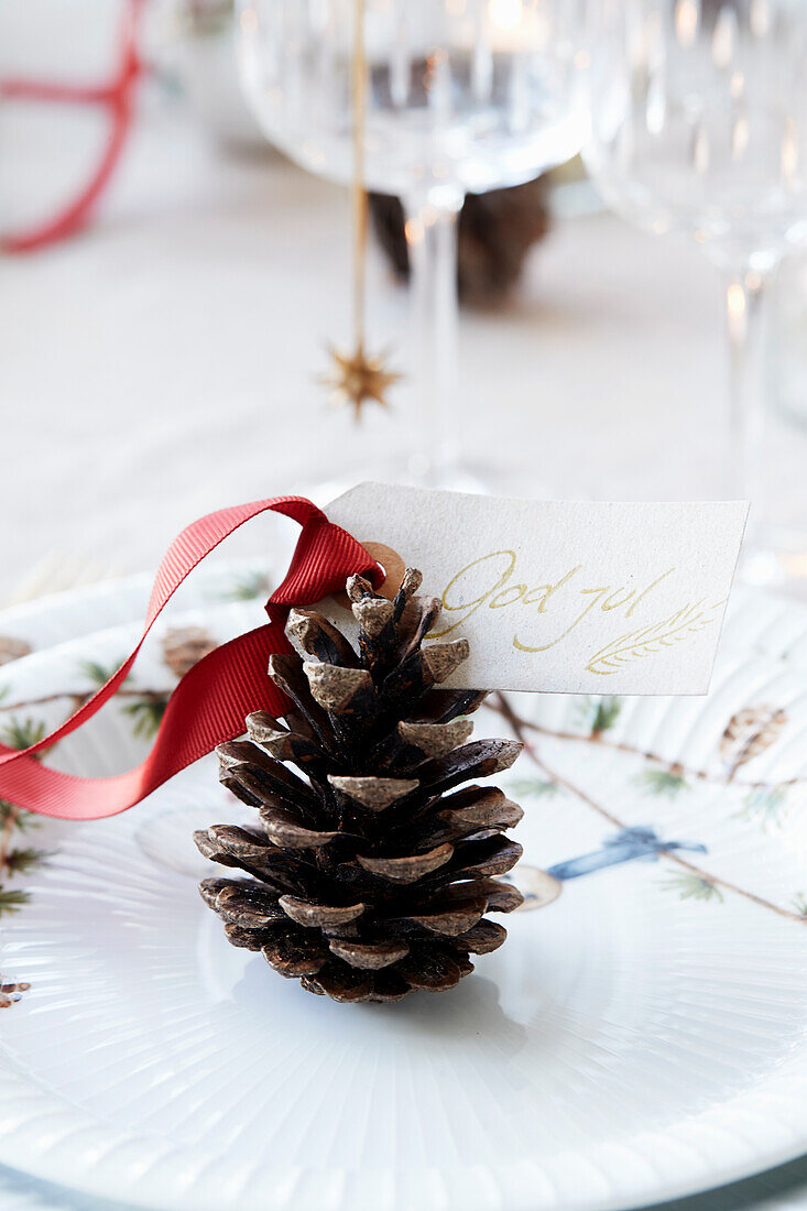 Pine cone used as place card holder on Christmas place setting