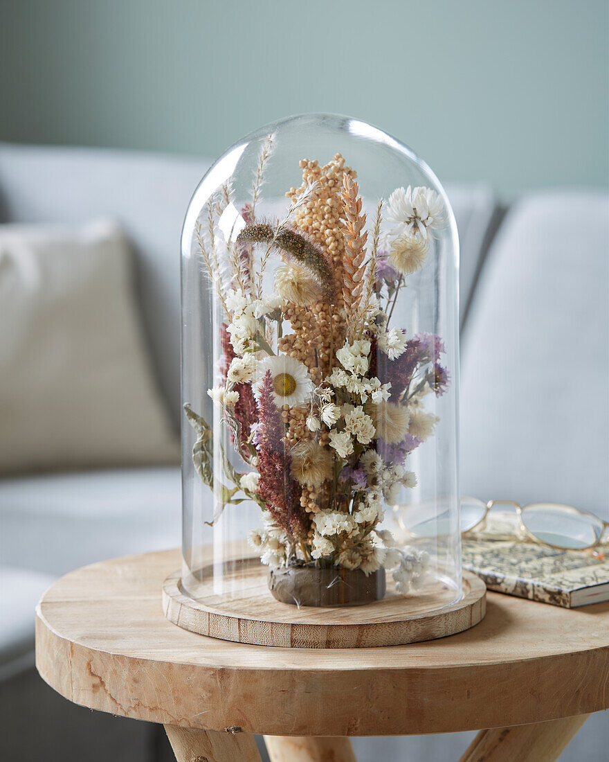 Dried flowers arrangement in glass stolp