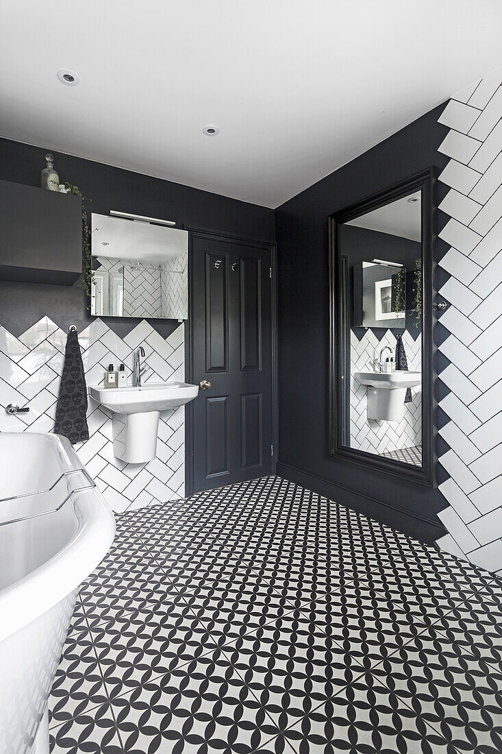 Large wall mirror in the bathroom with black and white floor tiles