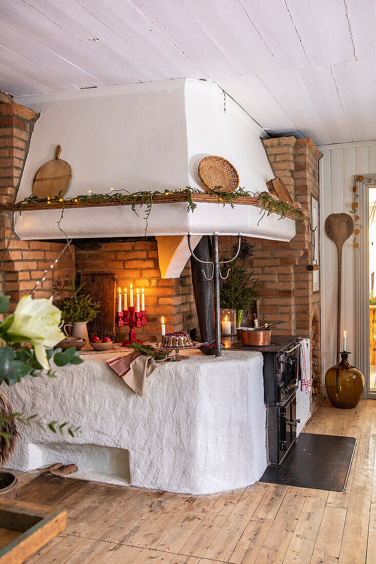 Cosy kitchen area with brick fireplace and Christmas decorations