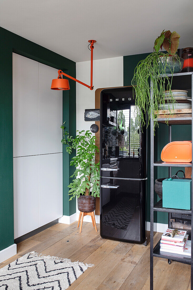 Kitchen area with black fridge and retro accents