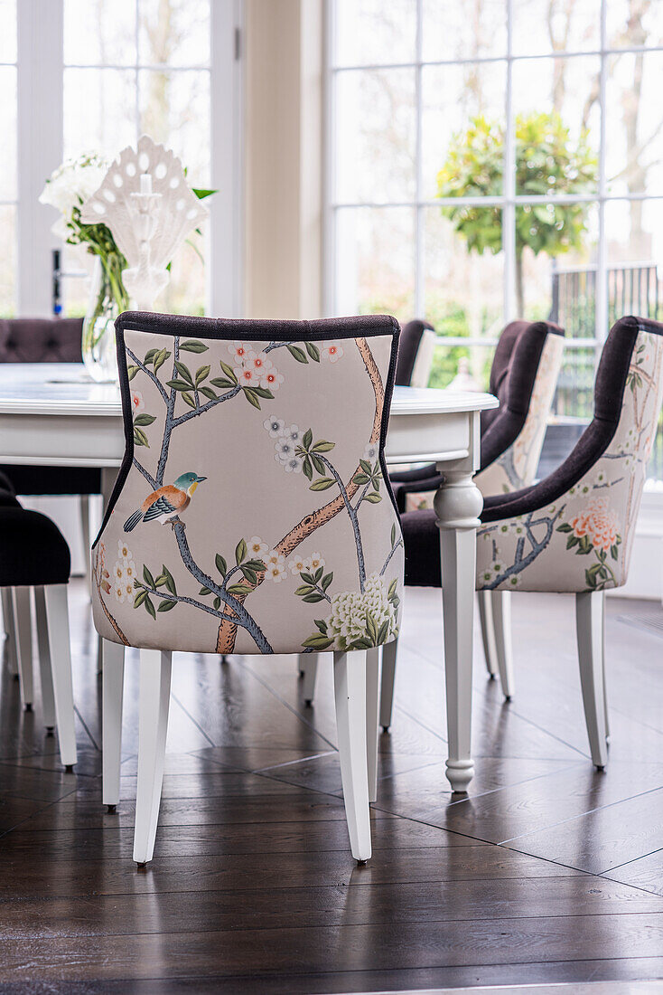 Dining set with floral chairs in chinoiserie style, daylight through window