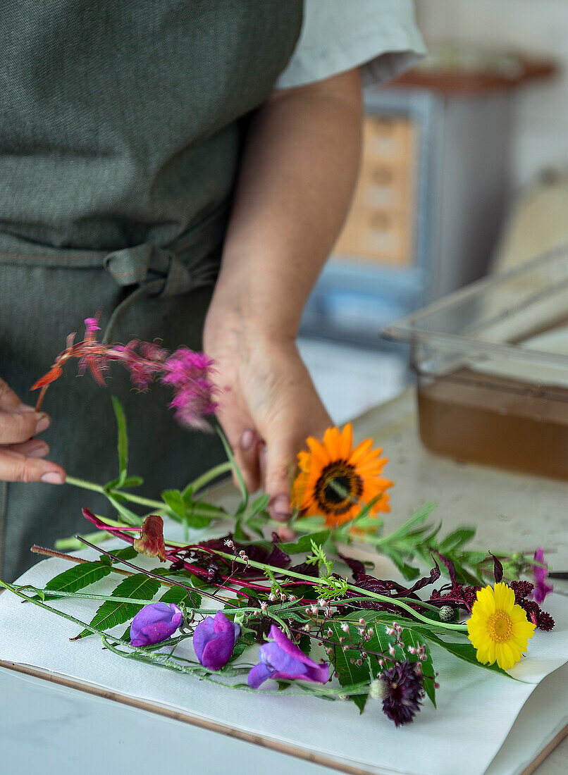 Woman working with freshly cut wildflowers