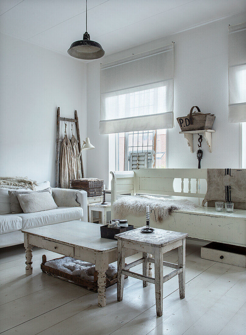 Bright vintage-style living room with white wooden furniture and fabric blinds