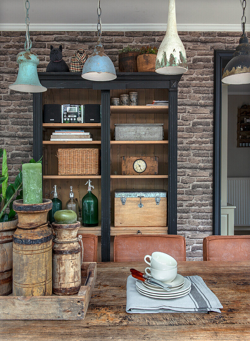 Industrial-style dining area with brick wall and wooden table