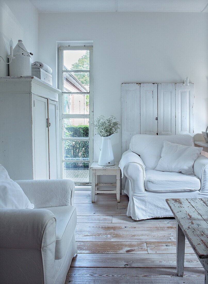 Bright living room with white furniture in shabby chic style