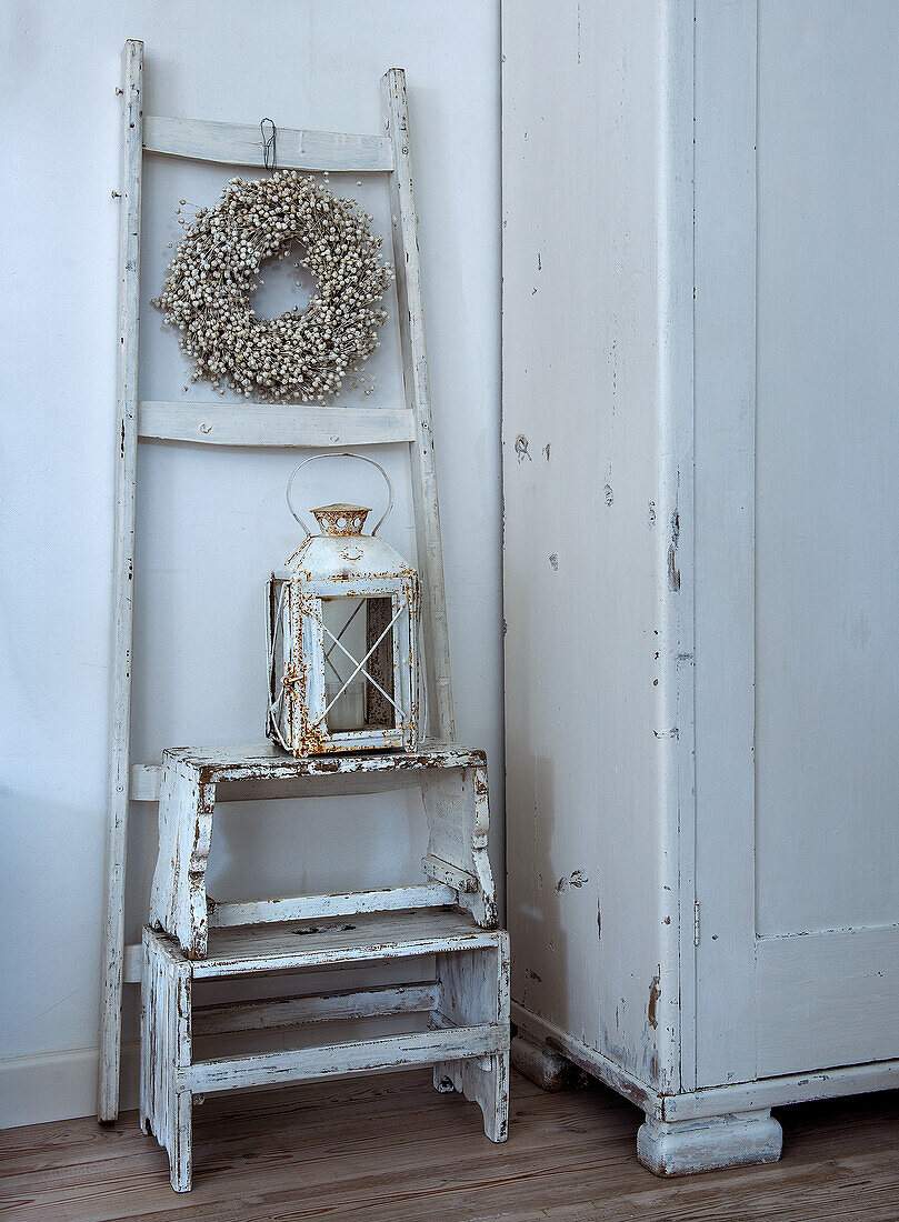 Wooden stool with rustic lantern and floral wreath