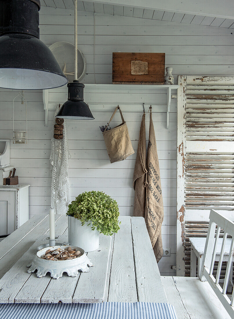 Dining area in shabby chic style with white wooden furniture