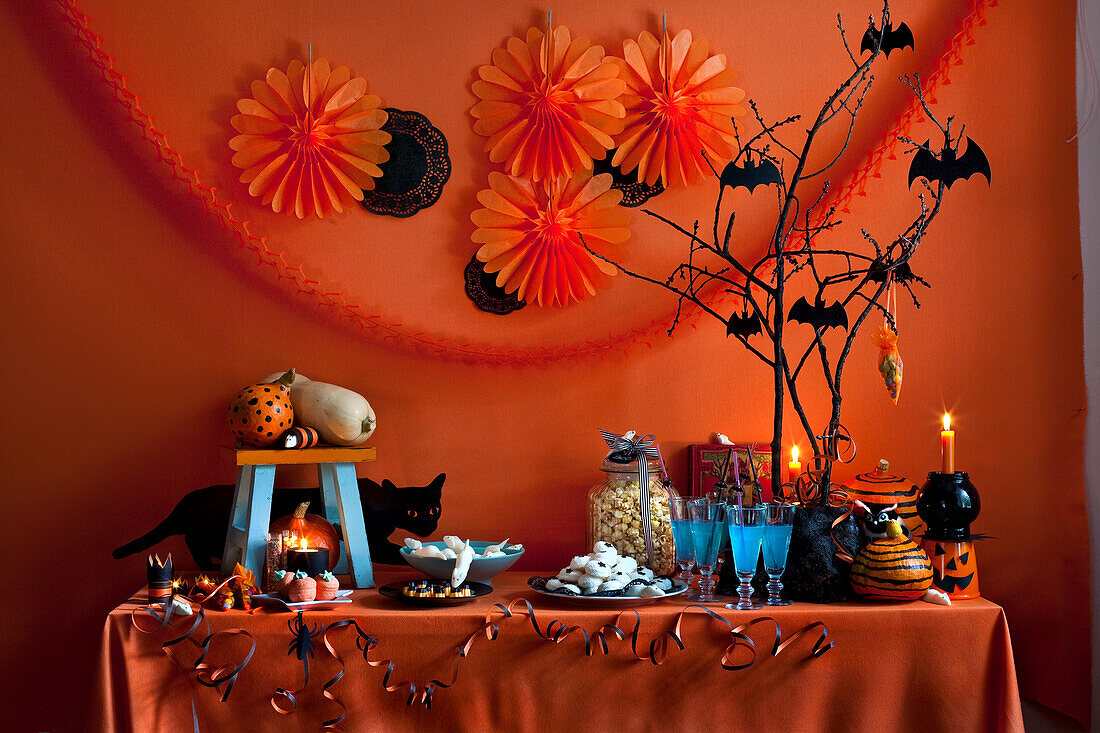 Halloween buffet with black bats, streamers and paper decorations