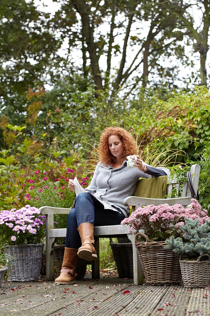 Woman relaxing on autumn terrace