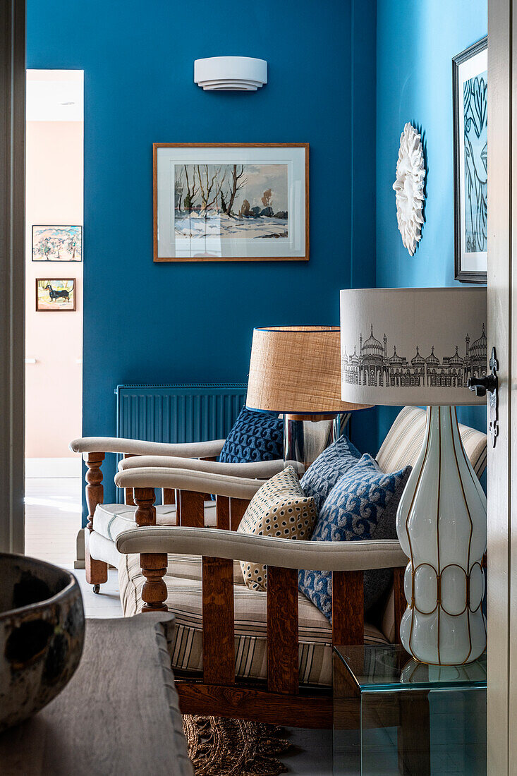 Sitting area with wooden furniture and blue walls in the living room