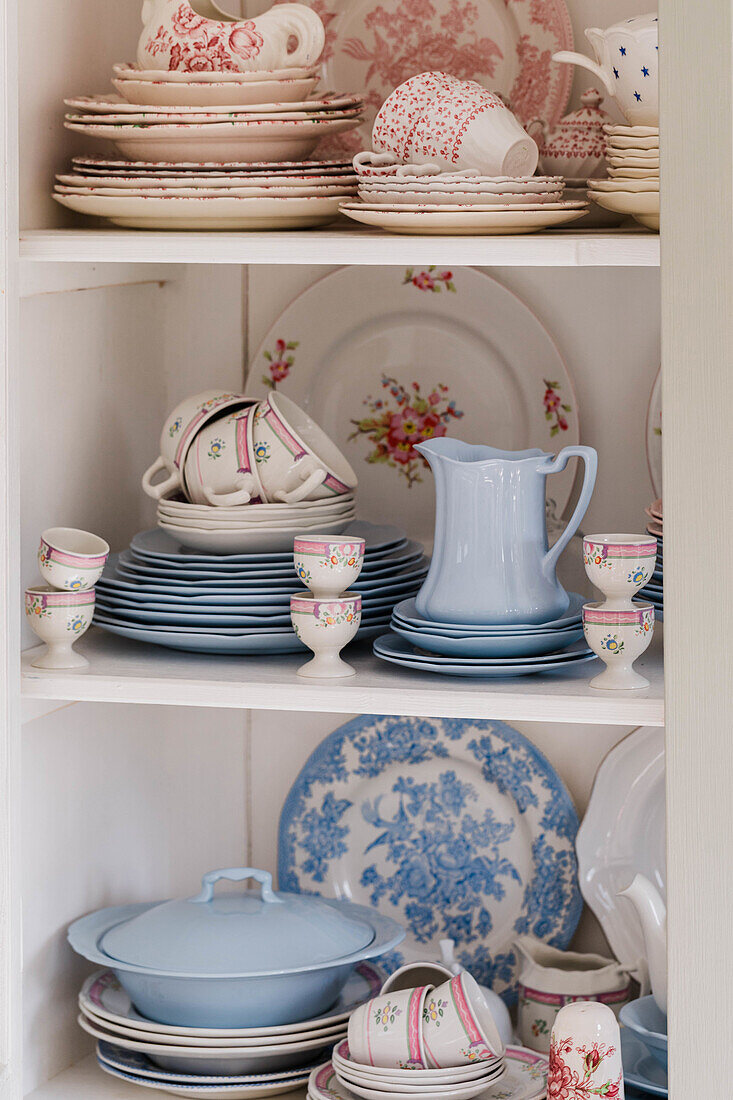 Vintage country-style crockery in white, red and blue with floral patterns