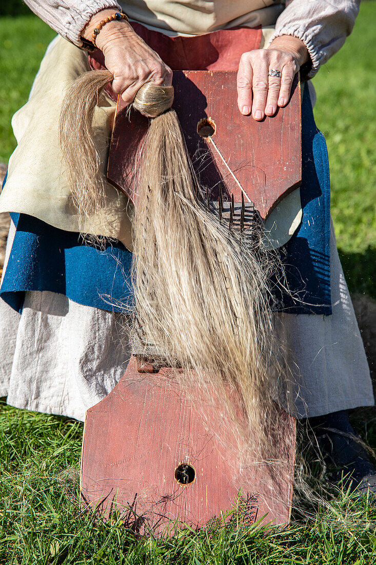 Manual labour with flax outdoors in a meadow