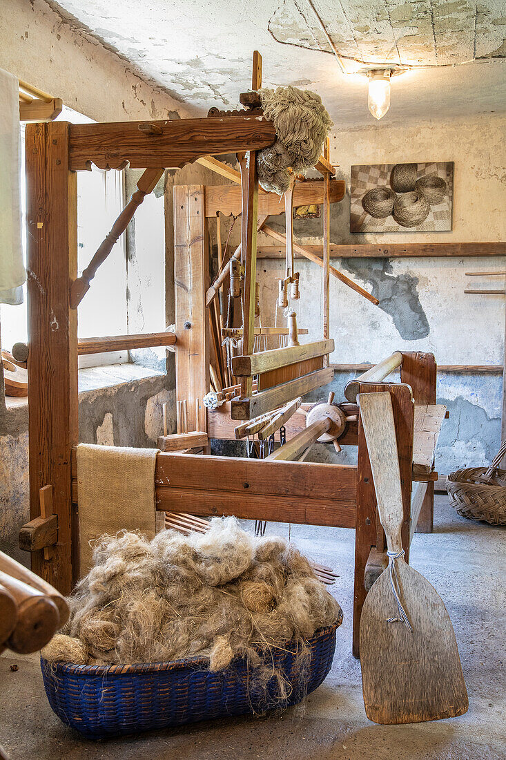 Traditional loom with natural fibres in a rustic studio