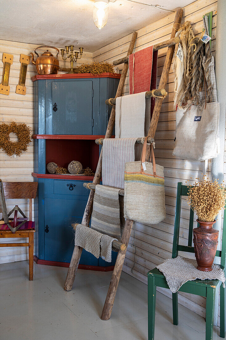 Rustic room with wooden ladder and textiles