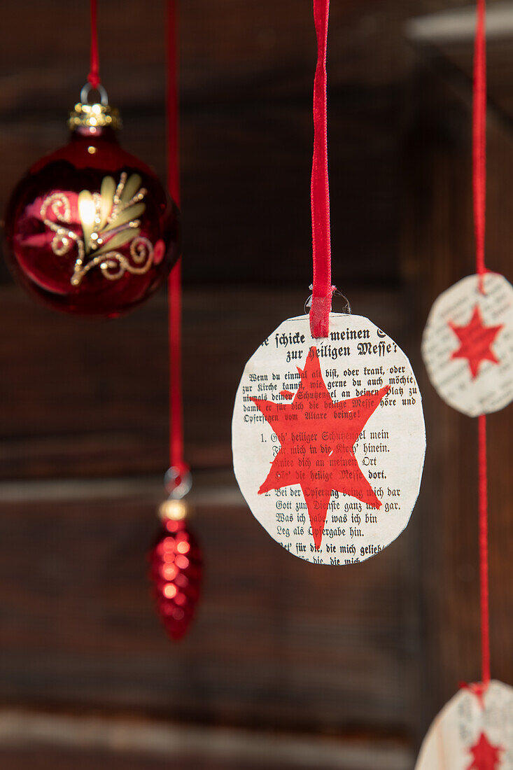 Homemade Christmas decorations made from paper and red ribbons