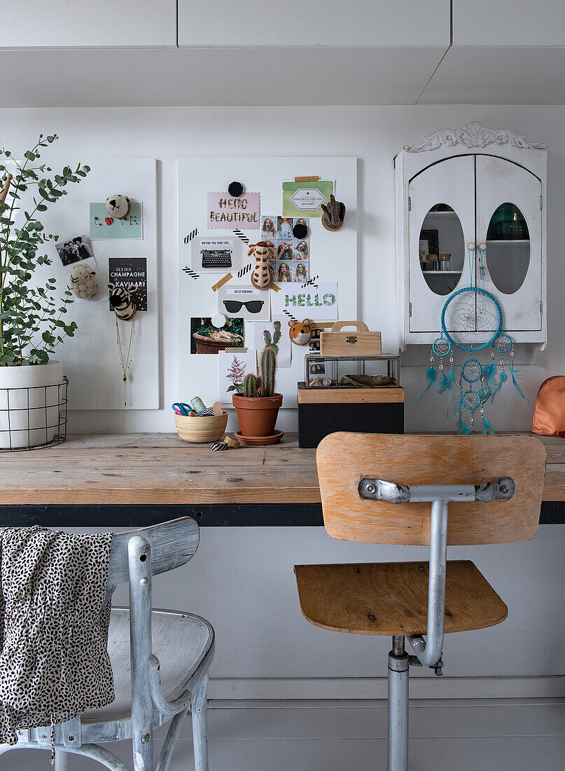 Workspace with wooden desk, plants and decorations