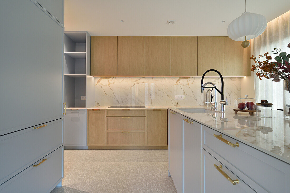 Modern kitchen with marble worktop and wooden elements in Warsaw