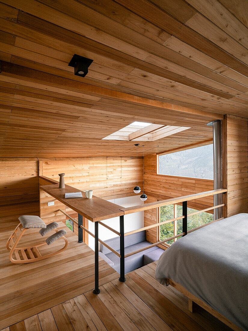 Gallery with sleeping and reading area, wood paneling and skylight