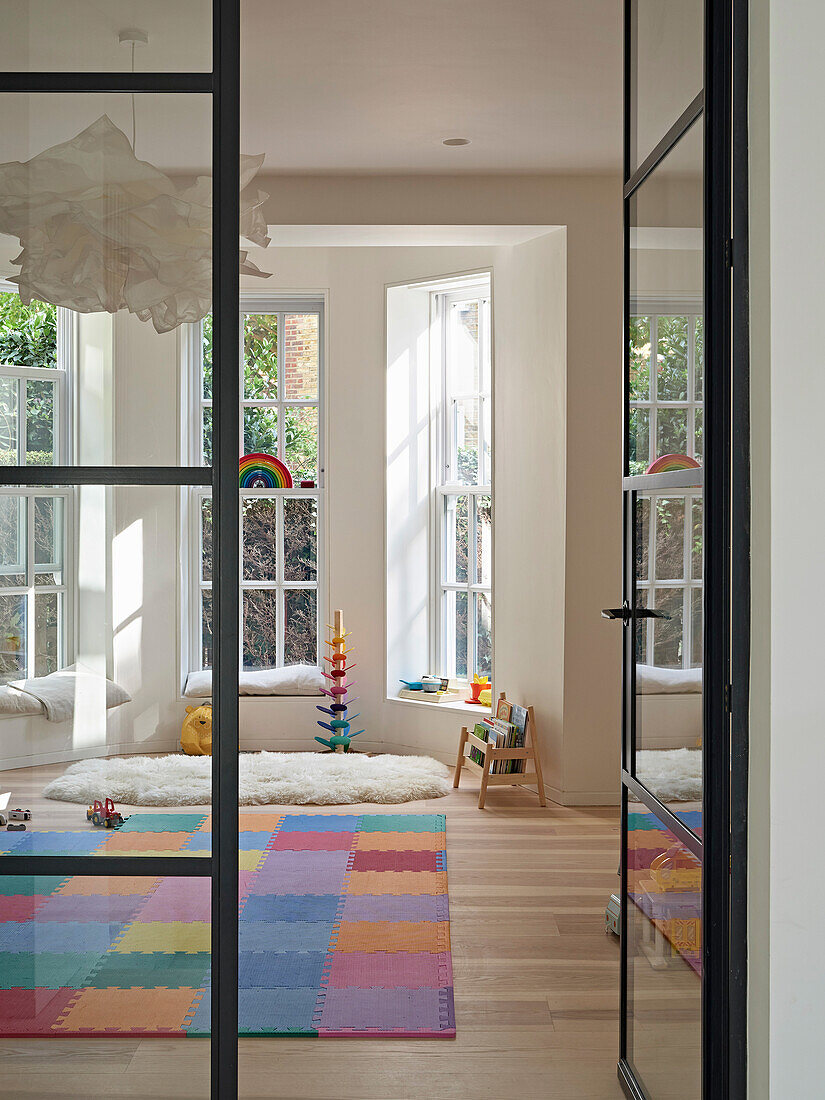 View through glass door to colorful and bright playroom